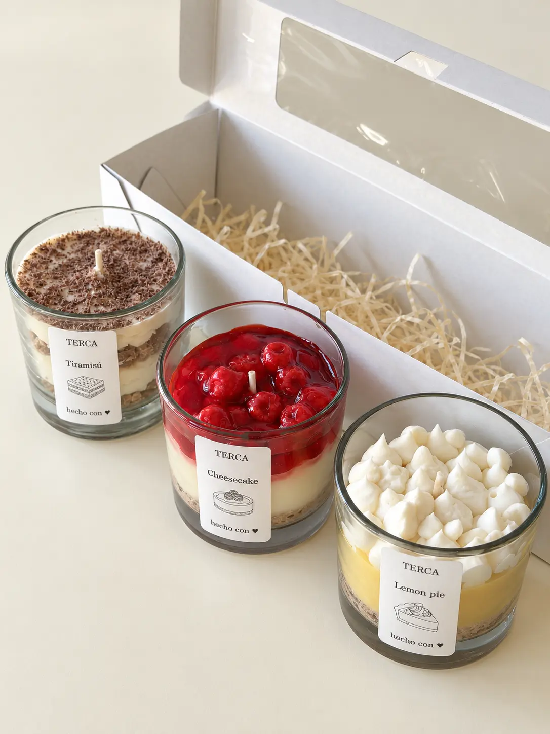 Las tres velas TERCA de la edición ANTOJO — Tiramisú, Cheesecake y Lemon pie — junto a su caja blanca abierta